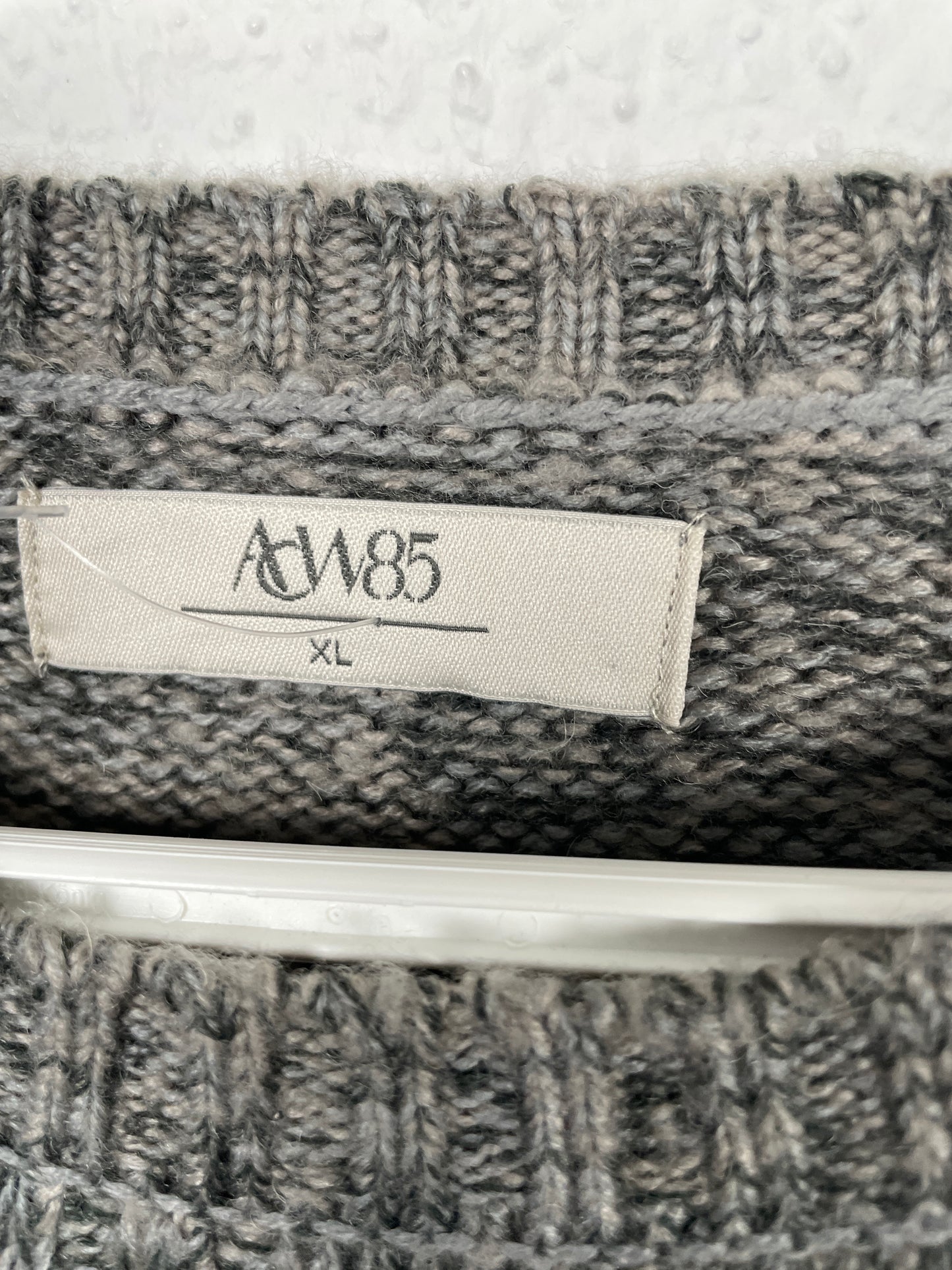 Grey cable-knit sweater by AW85.